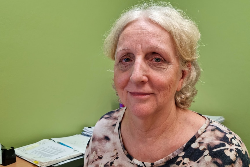 Family Planning NT chief executive Robyn Wardle sitting at her desk and looking at the camera.