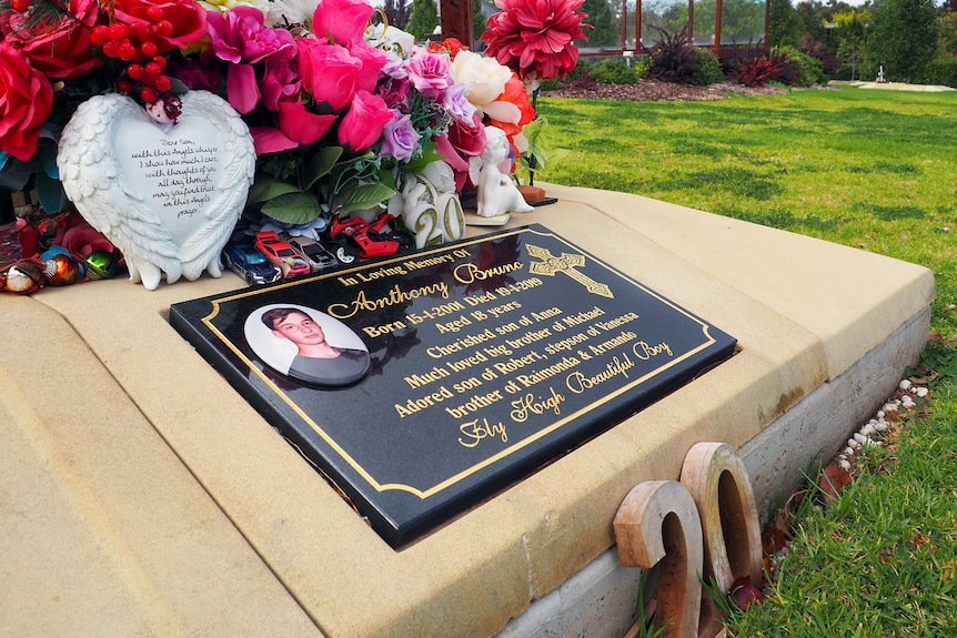 The tombstone and flowers of teenager Anthony Bruno
