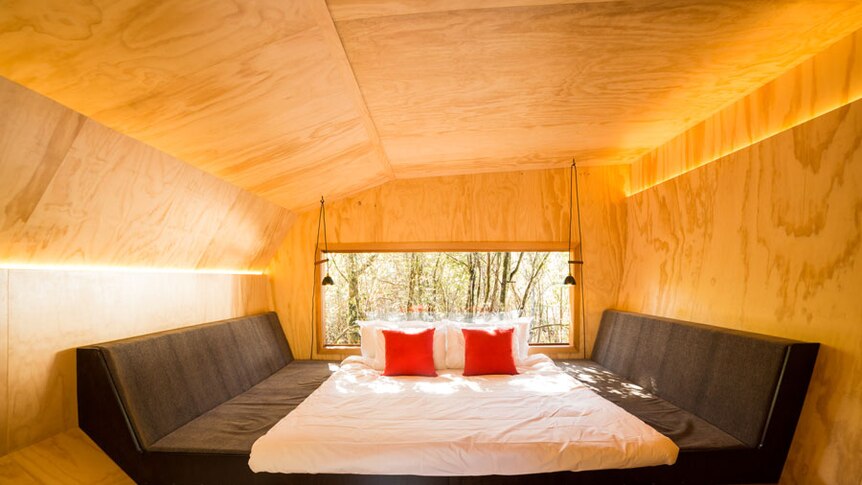 A double bed inside a luxury accommodation pod.