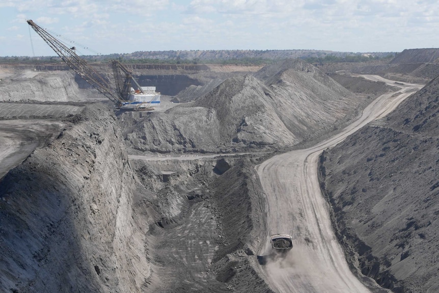 An open cut coal mine with a dragline and dump truck operating