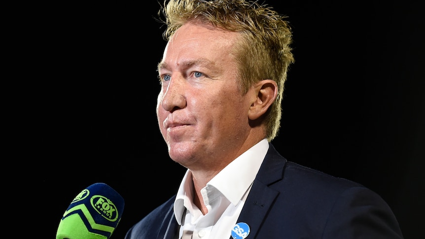 A man looks on as he coaches an NRL match