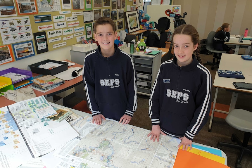 Two children standing in classroom