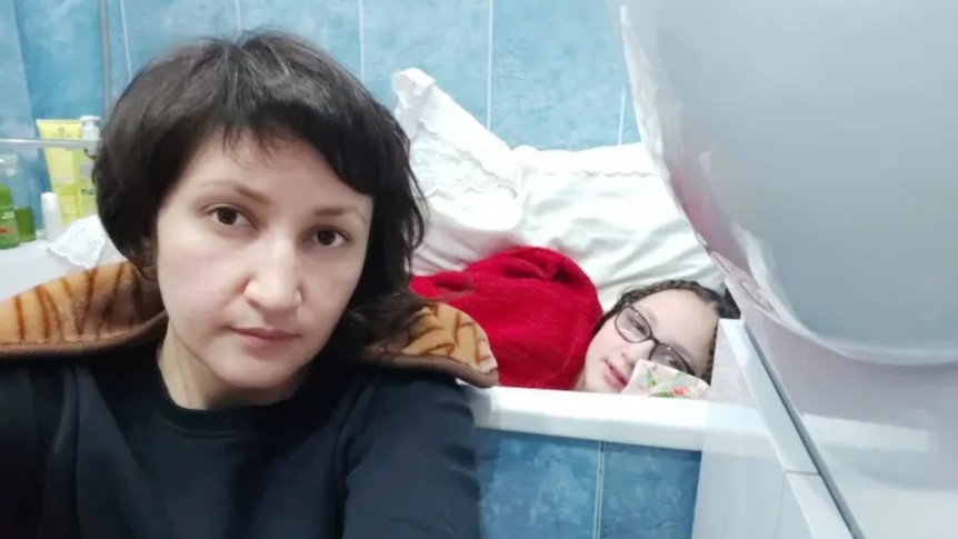 Zakhida Adylova and her daughter have been sheltering in the bathroom of their Kyiv apartment.