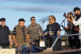 A group of male singers on stage performing.