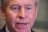 A tight shot of Colin Barnett's face.