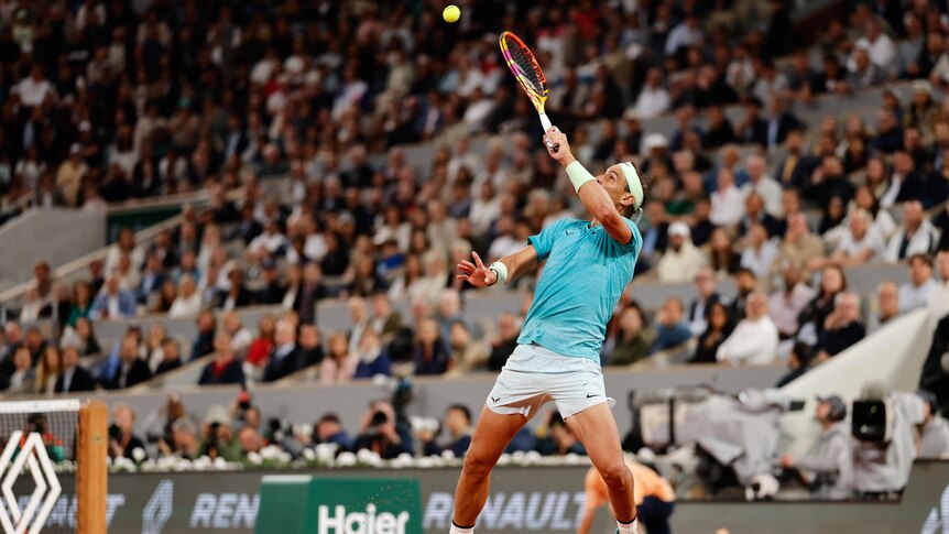Rafael Nadal plays an overhead smash at the French Open.