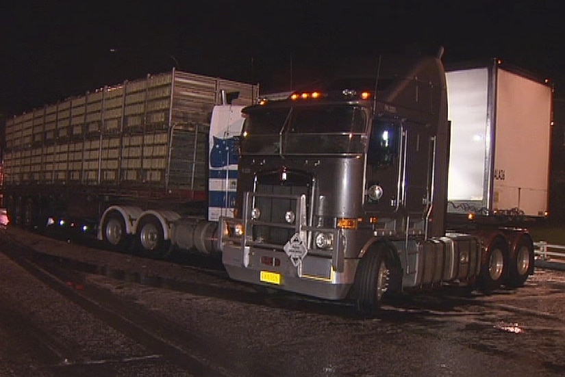 A semi-trailer crashed into a B-double and then collided with a police car on the Freeway