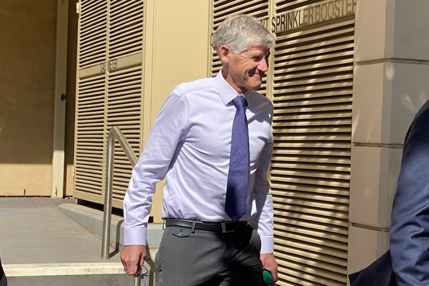 A man walking out of court in a suit