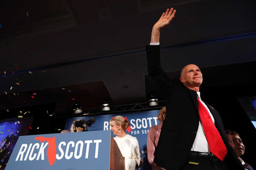 Rick Scott waves to supporters at an election watch party.