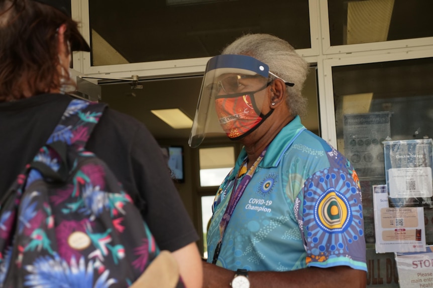 Leila Cobbr is getting vaccinated by a health worker.