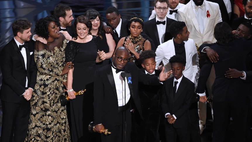 Barry Jenkins, foreground centre, and the cast accept the award for best picture for Moonlight at the Oscars.