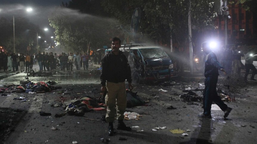 A policeman stands guard at the scene after a blast in Lahore.