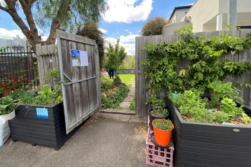An open door leading to a community garden in inner Melbourne