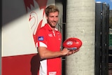 Sydney Swans defender Alex Johnson poses with a football on August 1, 2018.