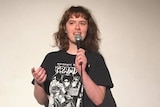 A photo of Eurydice Dixon performing stand up comedy.