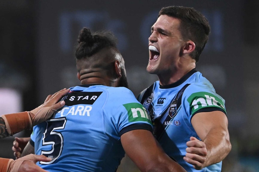 Nathan Cleary and Josh Addo-Carr hug as Tyson Frizell and Clint Gutherson look on after a NSW Blues try in State of Origin II.