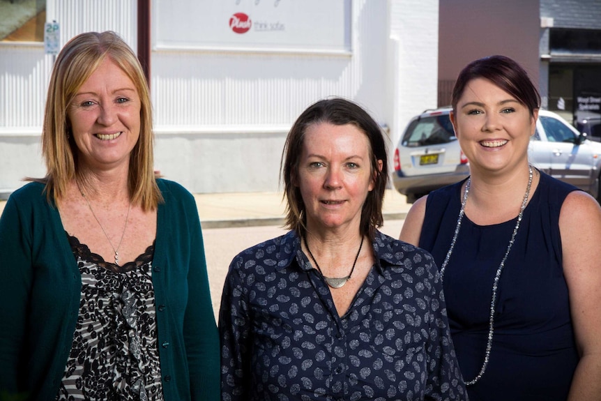 Alison Crowe, Deborah Hart and Rebecca Plain stand by the side of a street.