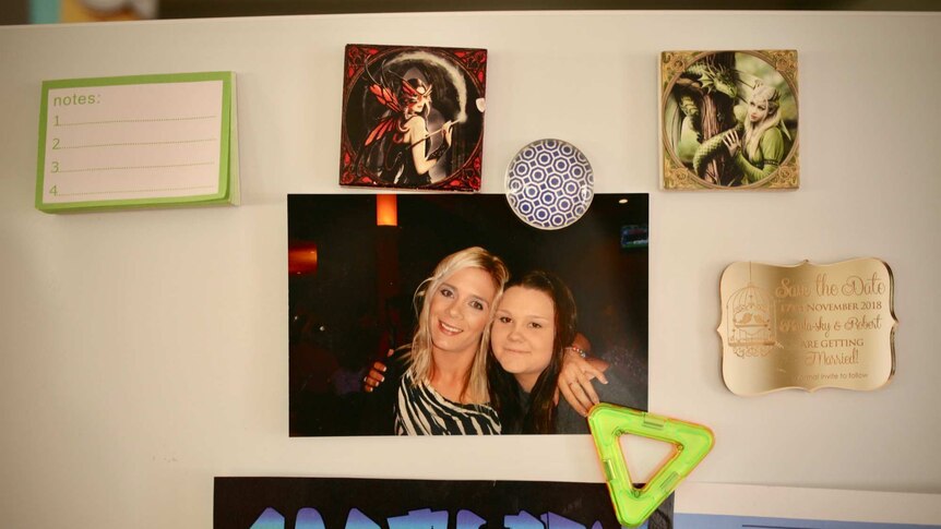 A photo of Tara Costigan and her sister Rikki on their aunt, Maria Costigan's fridge.