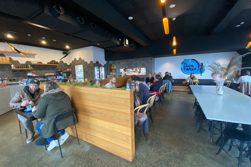 cafe with spaced out seats and people eating