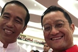 Indonesian President Joko Widodo takes a selfie with minister Juliari Balubara