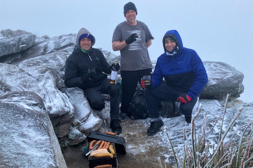 Hikers cooking in snow on a mountain