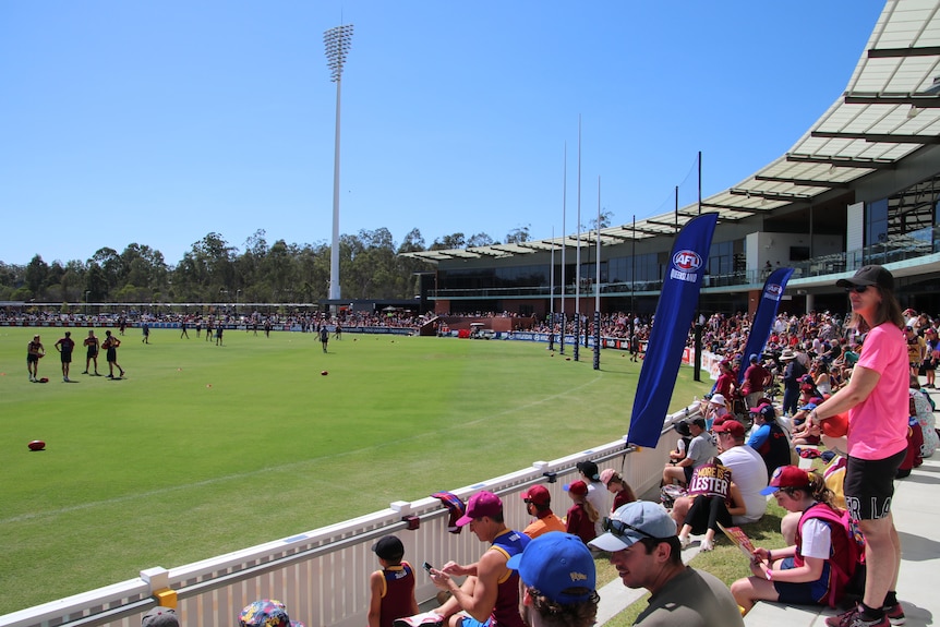 The crowd watches Brisbane Lions as they train