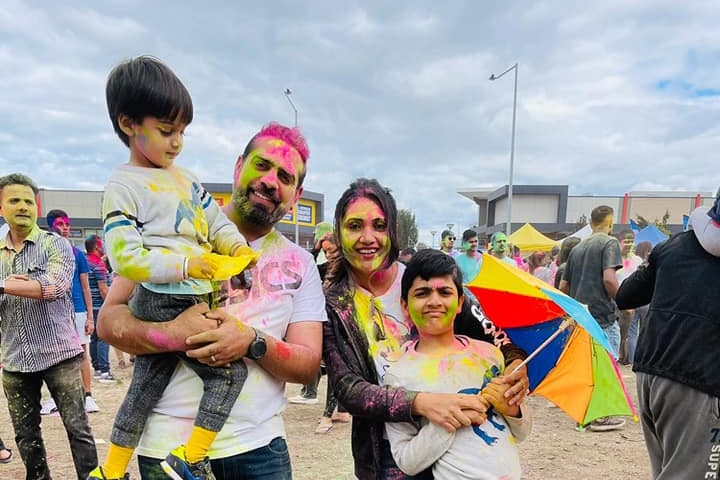 A family celebrating a colour festival