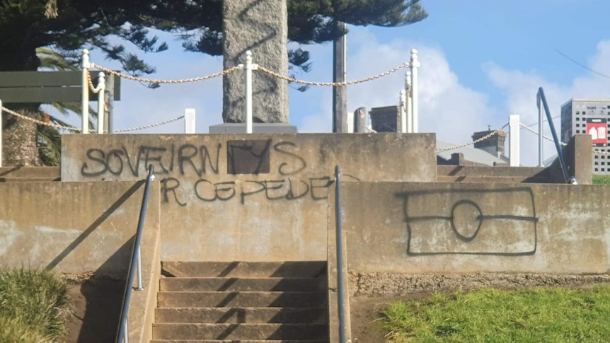 A picture of a graffitied monument in Portland.