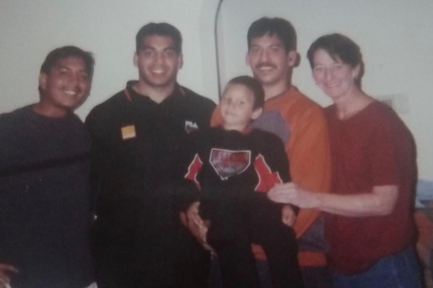 A family poses the morning of an AFL grand final