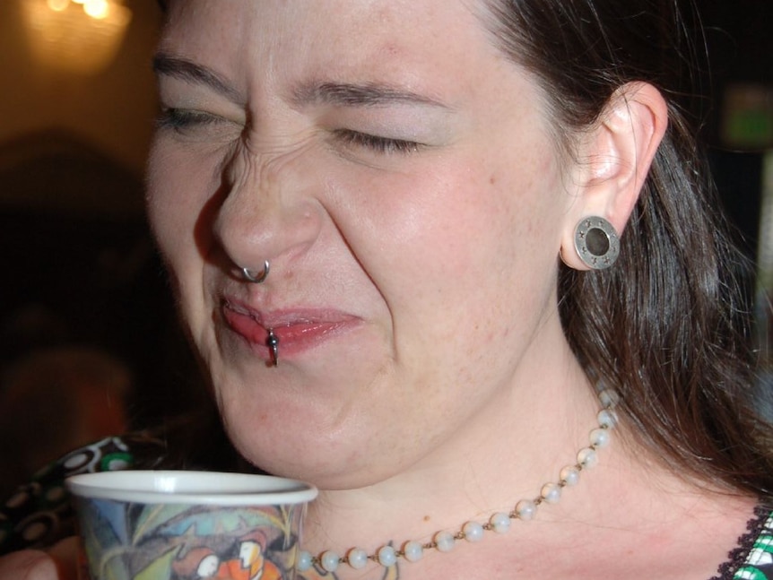 Woman drinking bitter coffee.