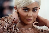 A close up of Ms Jenner with blond hair and nude sparkly dress.