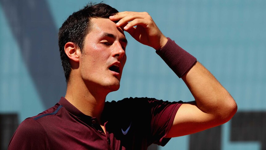 Australia's Bernard Tomic shows his dejection against Fabio Fognini at the Madrid Open.