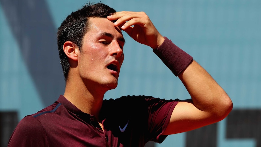 Australia's Bernard Tomic shows his dejection against Fabio Fognini at the Madrid Open.