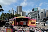The crowd watches on as Oprah Winfrey hosts her show on the steps of the Sydney Opera House