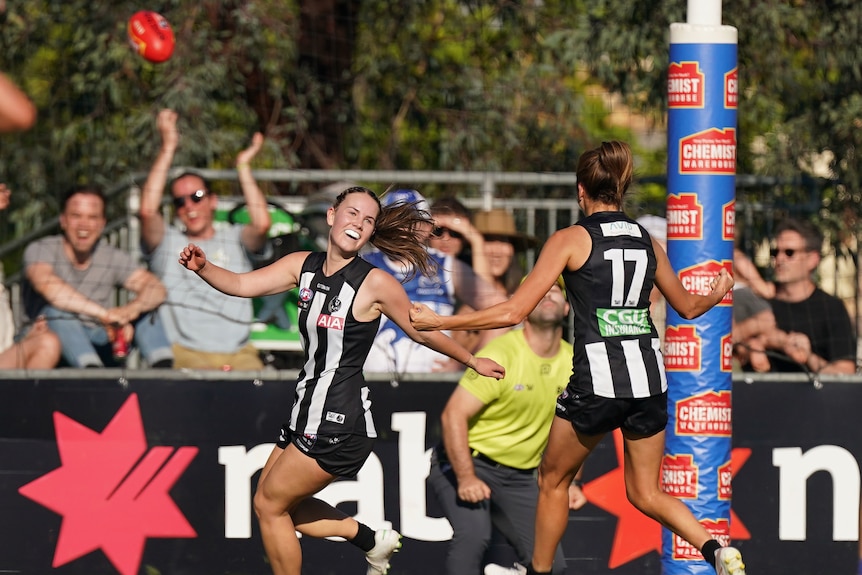 Collingwood's Tarni Brown is congratulated by Steph Chiocci