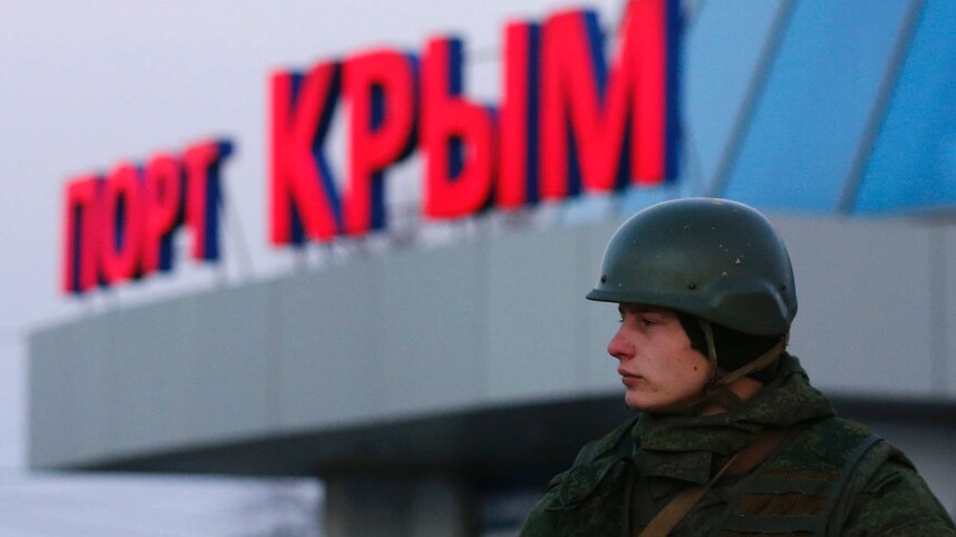 Armed soldier guards Crimea's port