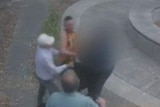 A still from CCTV footage shows bystanders rushing to help the father and son.