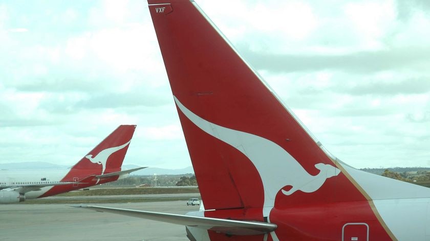 Two Qantas jets sit on the tarmac
