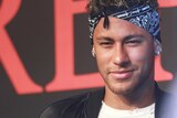 Neymar wears a bandana and earrings at a fashion event in Shanghai.