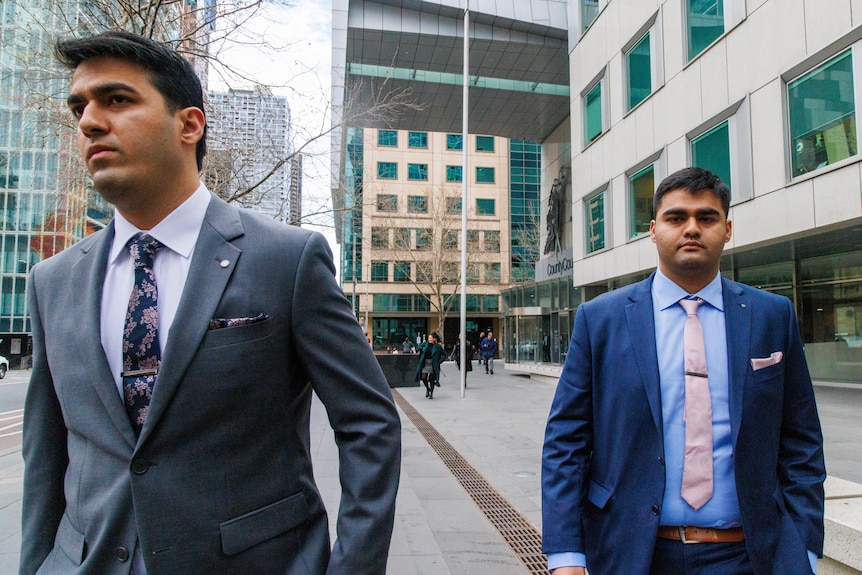 Obaid Khan and Shaheryer Khan outside the County Court of Victoria, dressed in suits.