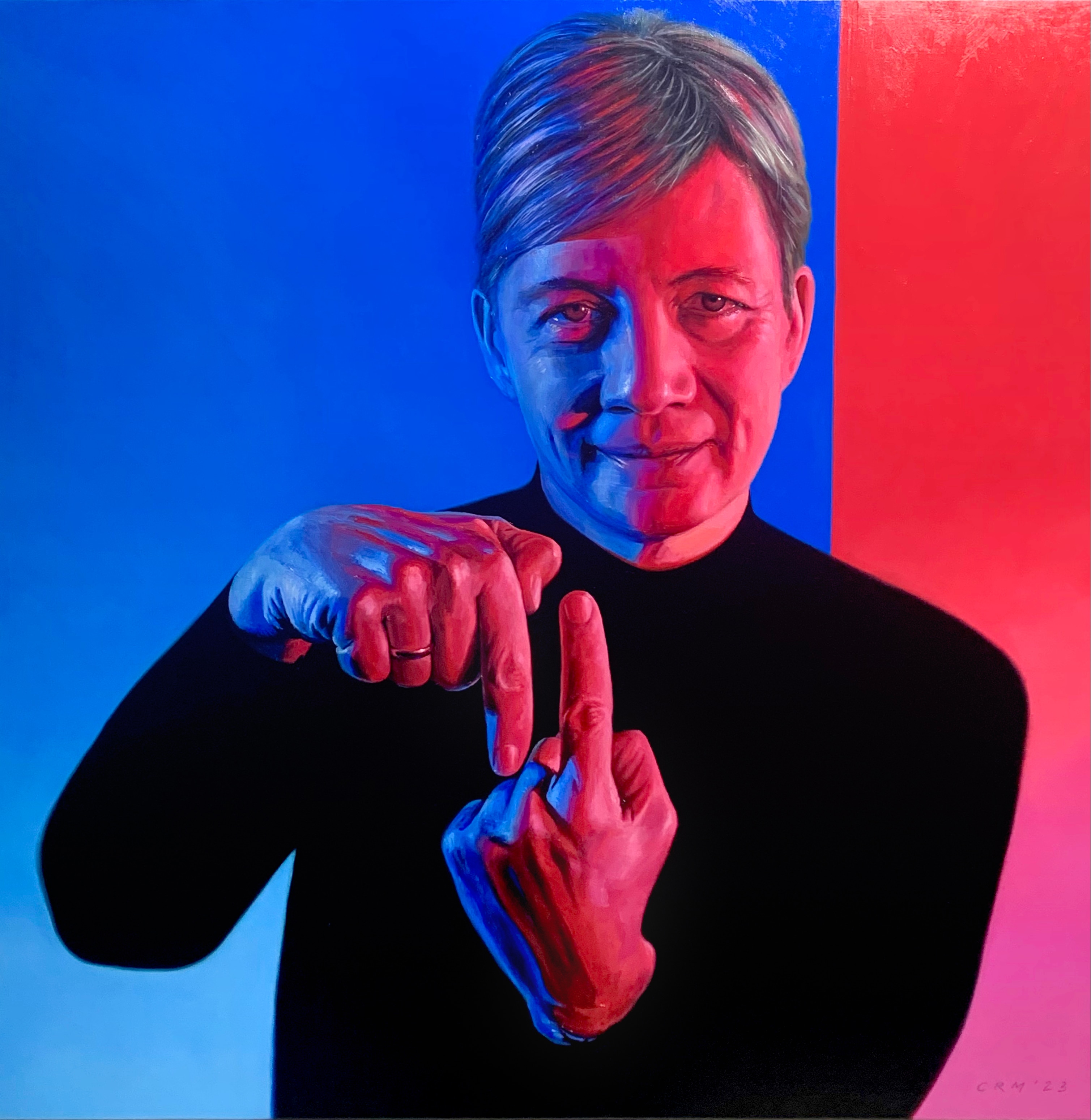 A portrait of Michelle Simmons. She is pointing one index finger up and the other index finger down