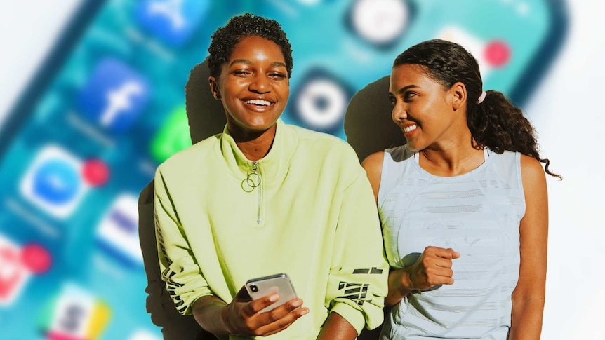 Two young women smiling with one holding a smartphone and a large icon of a smartphone looming behind them