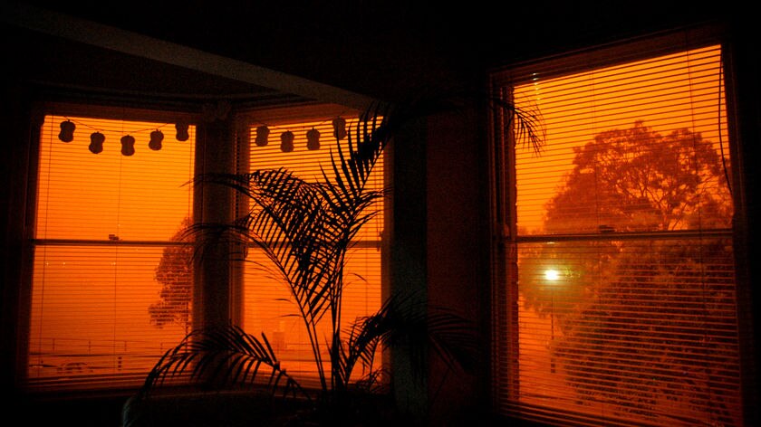 A red glow filters through a window in North Sydney during a dust storm on September 23, 2009.