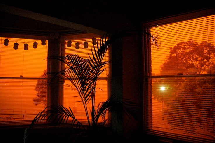 A red glow filters through a window in North Sydney during a dust storm on September 23, 2009.