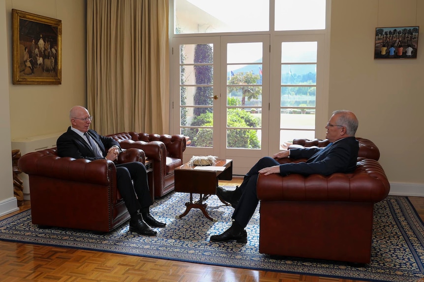 Governor-General David Hurley and Prime Minister Scott Morrison sit opposite each other on large brown couches