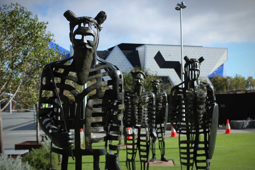 Sculptures depicting a group of Noongar men in a park in Perth
