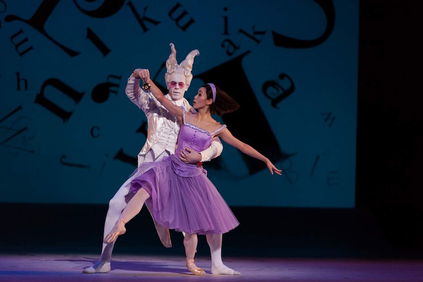 Two ballet dancers performing on stage.