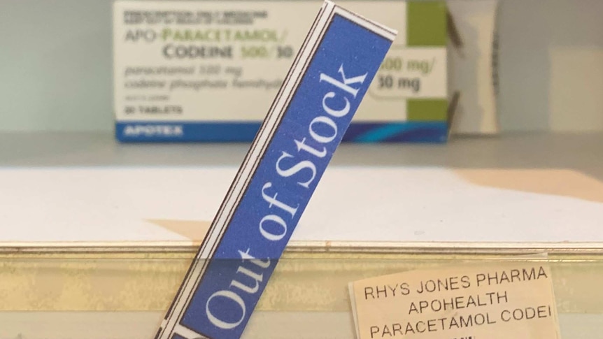 Out of stock sign on medicine shelf.