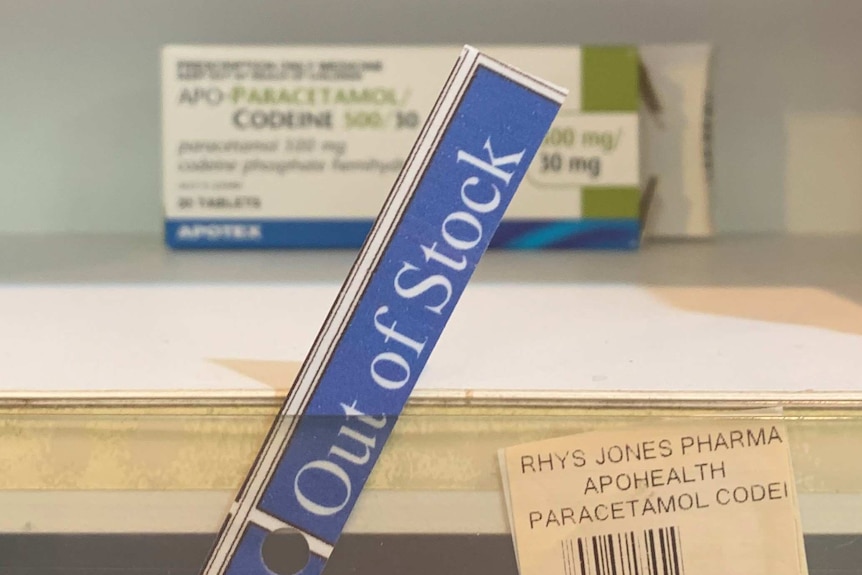 Out of stock sign on medicine shelf.