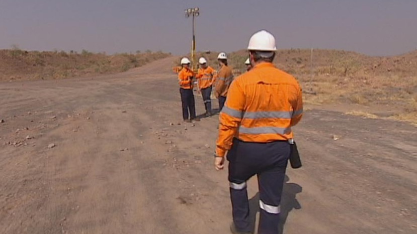 FIFO mining worker walks to group in outback